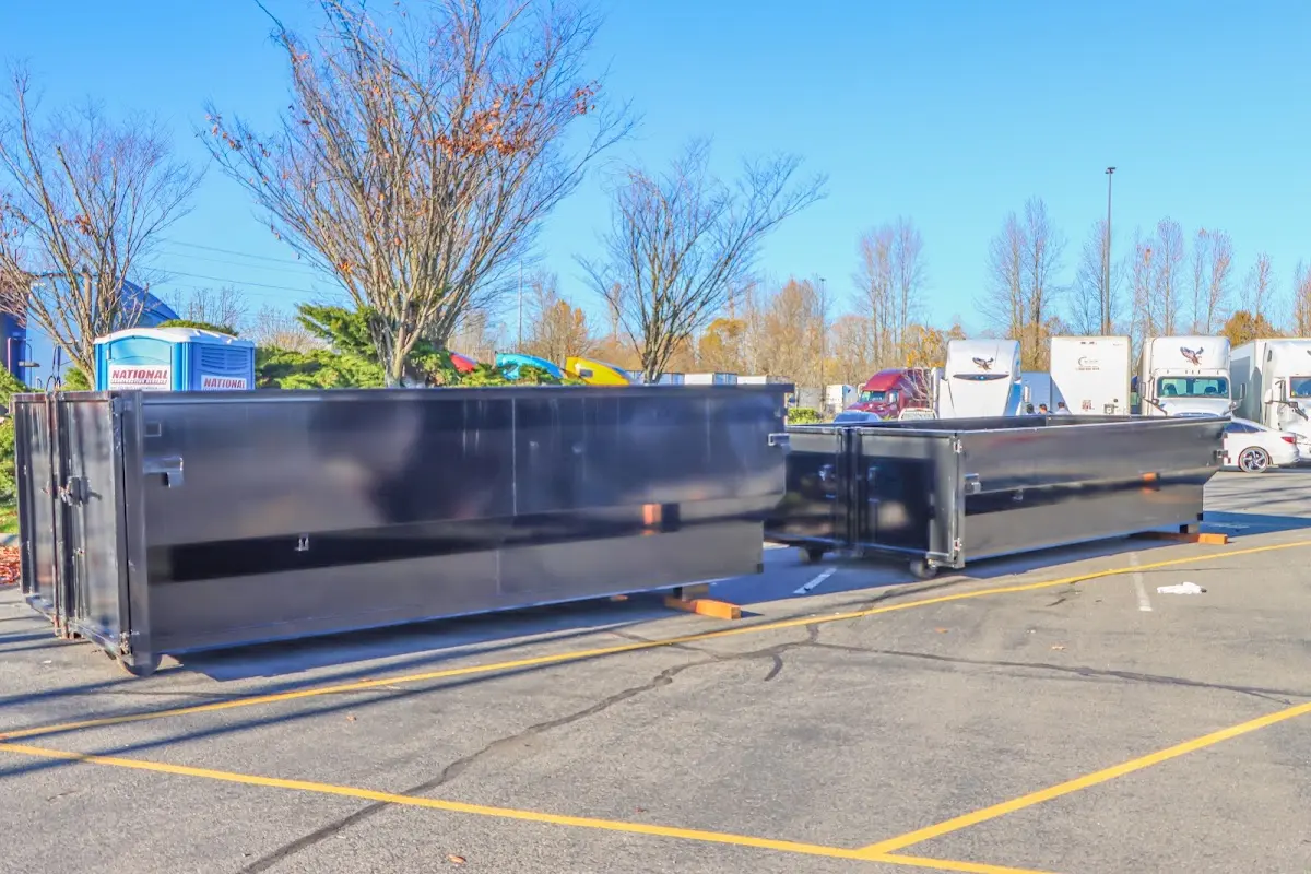 Professional dumpster rental service with roll-off container on residential driveway in McAllen